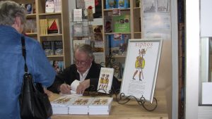 Book signing. Trying hard to concentrate.